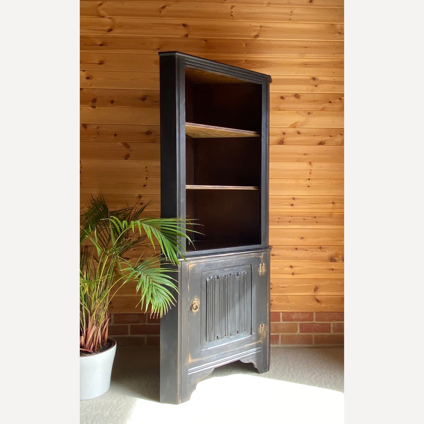 beautiful oak corner display cabinet with shelves to the top section & a cupboard in the bottom section. Made from solid Oak and is from furniture maker Remploy who were very popular during the 70s and 80s.
