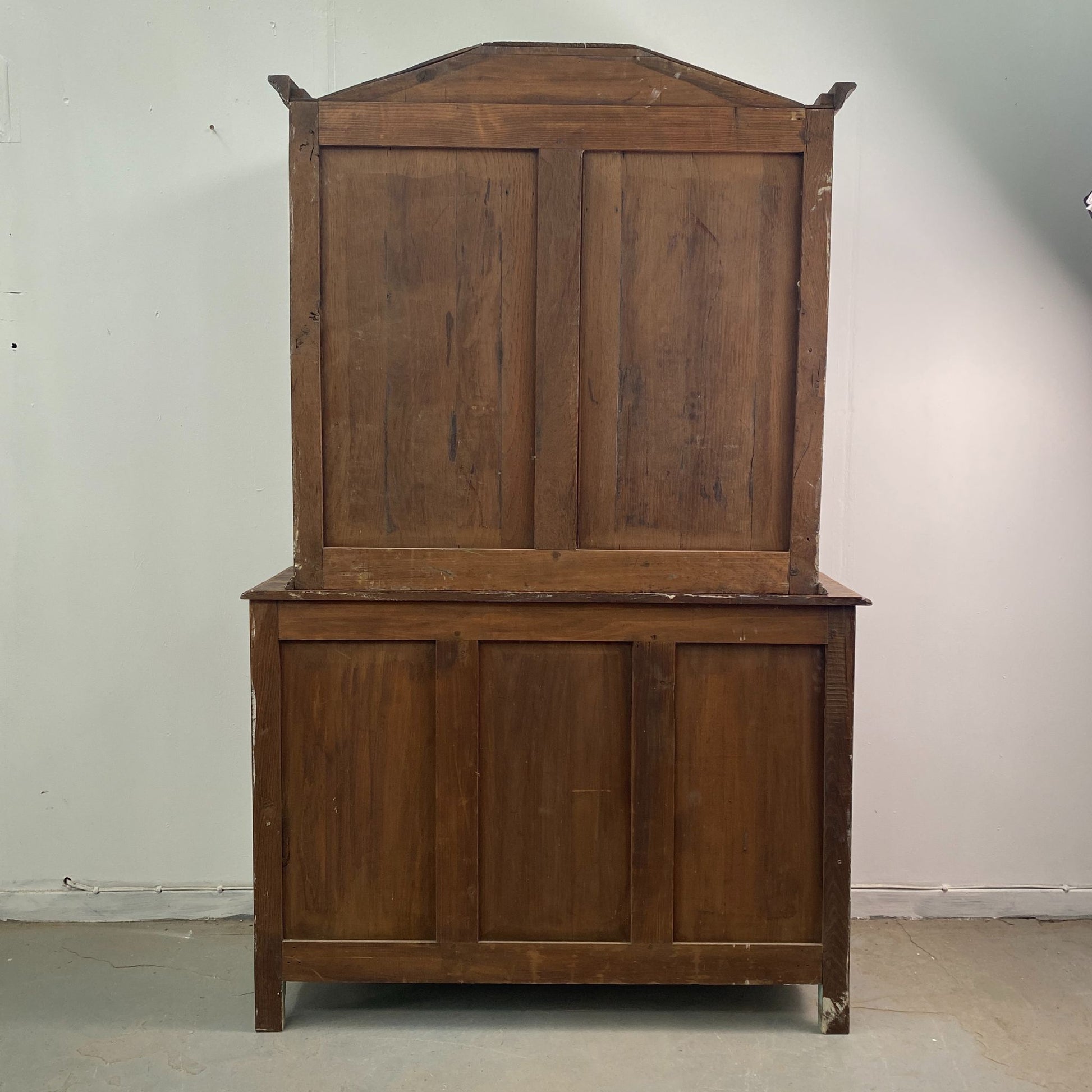 The back boards of a Stripped Oak Dresser with an aged patina in the style of a French Library