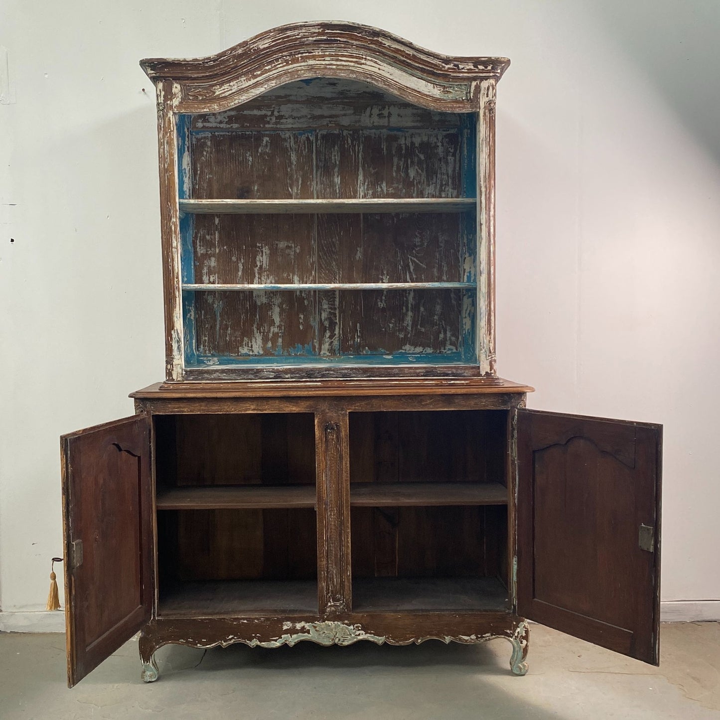 Detail showing the lower cupboard doors open of a Stripped Oak Dresser with an aged patina in the style of a French Library