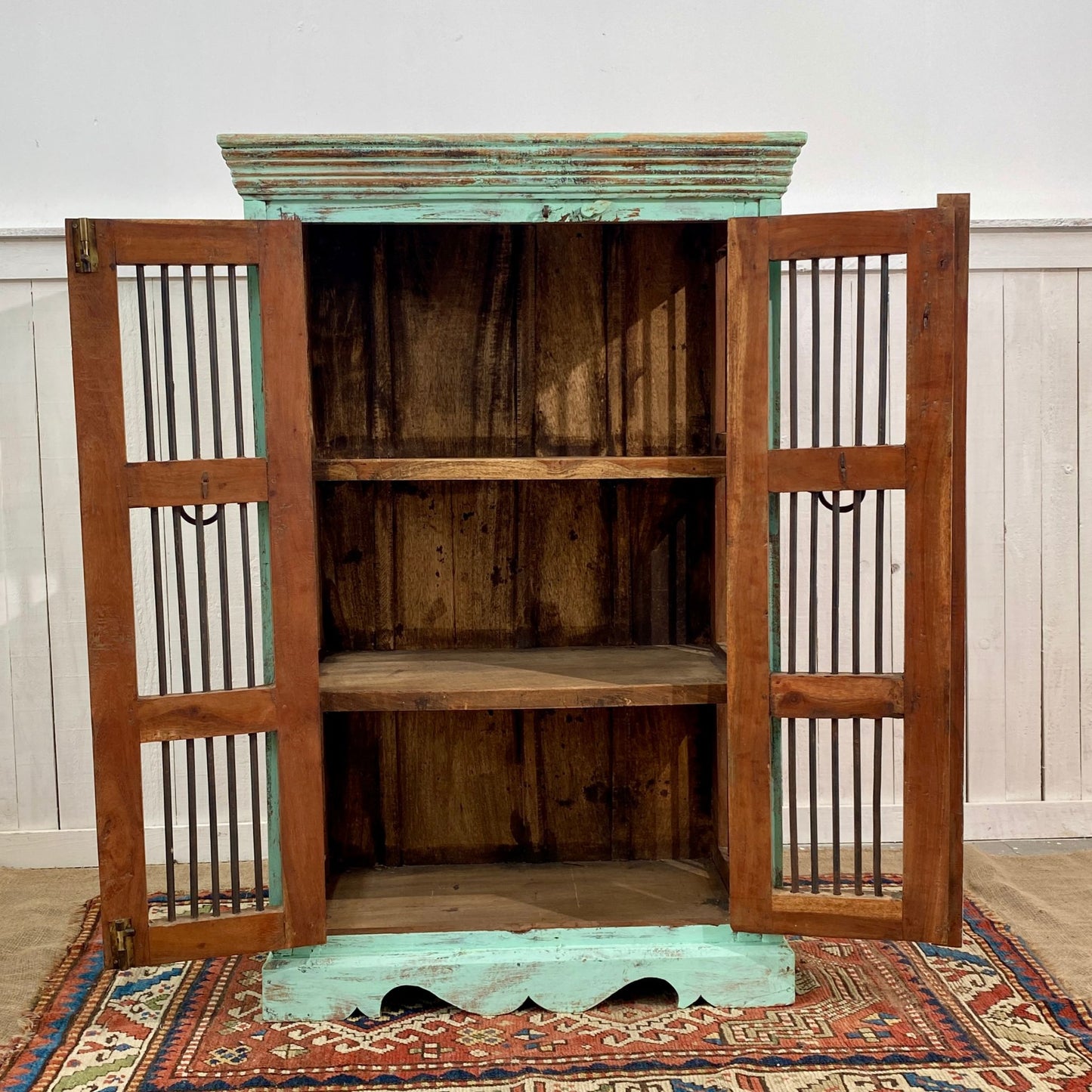 Indian Jali cabinet made from reclaimed antique teakwood with metal bars and both doors open.