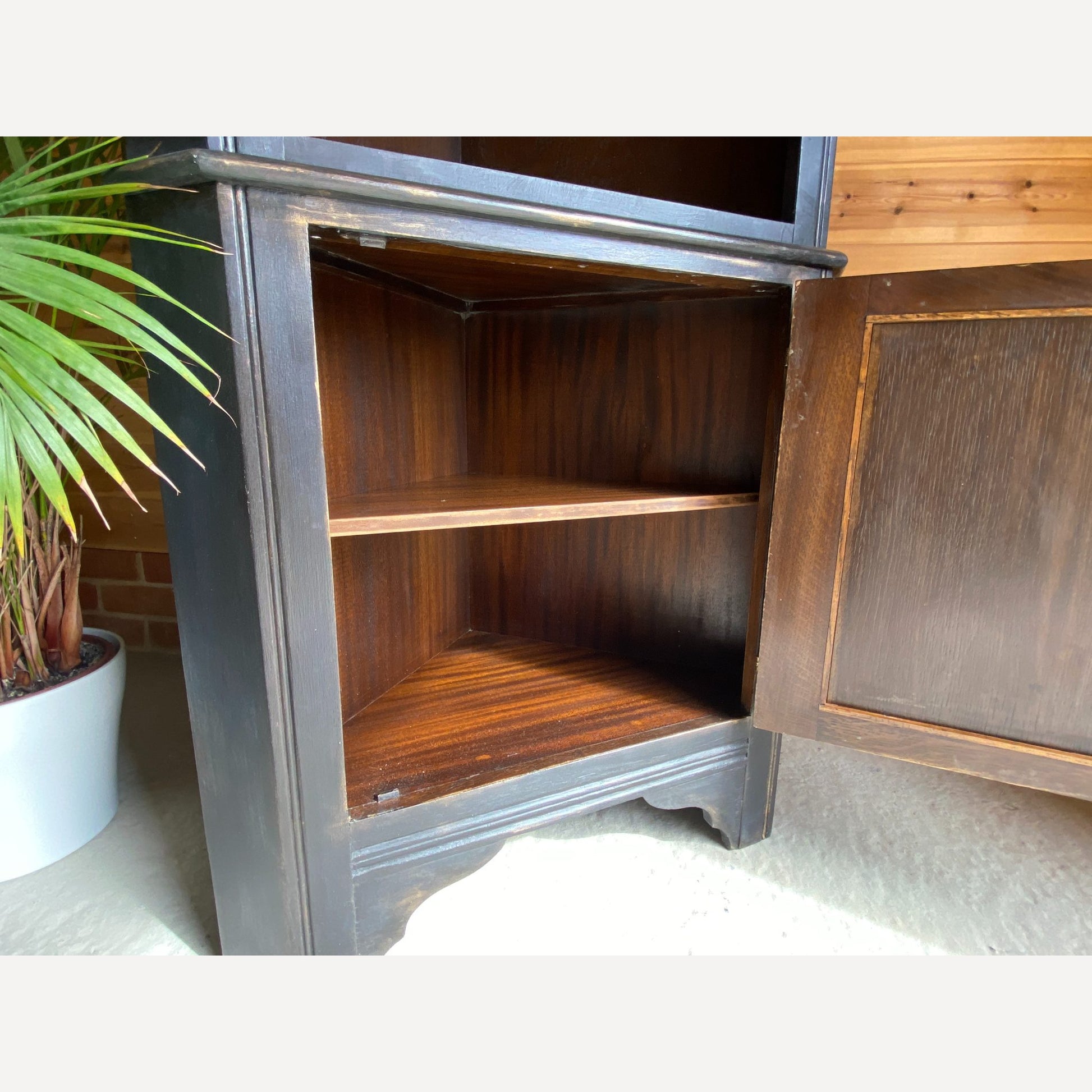 beautiful oak corner display cabinet with shelves to the top section & a cupboard in the bottom section. Made from solid Oak and is from furniture maker Remploy who were very popular during the 70s and 80s.