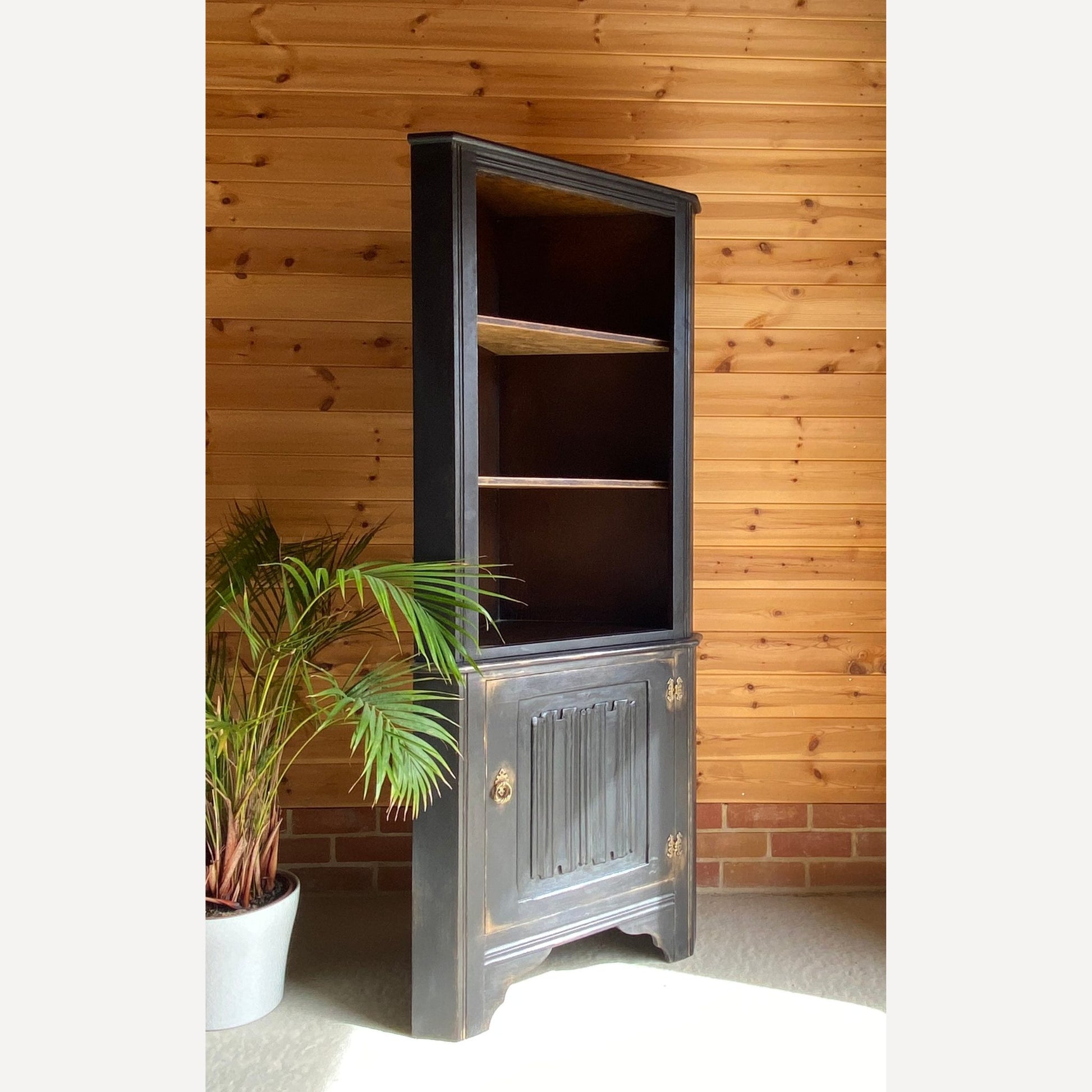 beautiful oak corner display cabinet with shelves to the top section & a cupboard in the bottom section. Made from solid Oak and is from furniture maker Remploy who were very popular during the 70s and 80s.